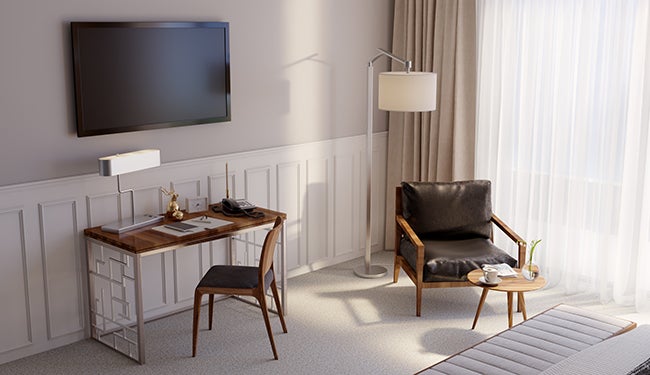 Floor lamp and desk lamp offer hospitality lighting in a hotel room